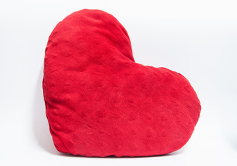 Red heart shape pillow on white background.
