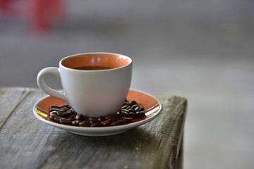 A Cup coffee and beans on wooden