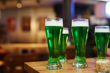 Group of glasses with Irish beer on wooden table