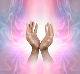 Male hands sensing Feminine Energy Field - male hands reaching up into a pink stream of light on a beautiful ethereal Angelic energy background with copy space
