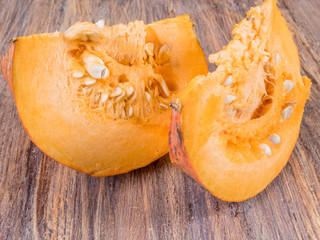 Cut yellow pumpkin on a wooden surface