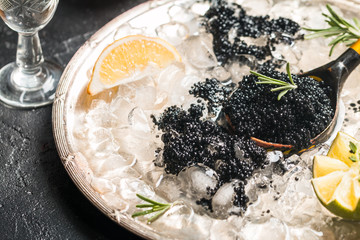 Black caviar in spoon - obrazy, fototapety, plakaty
