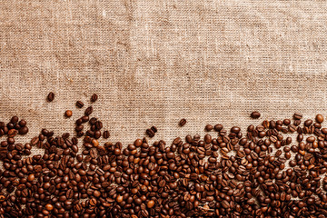 Coffee beans on burlap background