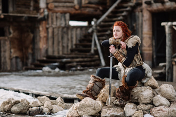 portrait of a girl in a Viking outfit, red hair.