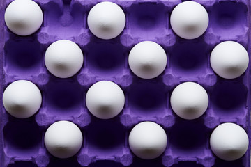 White eggs pattern in purple carton pack