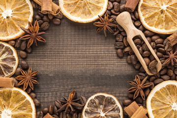 grapefruit and orange slices with coffee beans and spices on wooden background