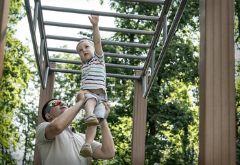Obraz premium Father and son exercising outdoor.
