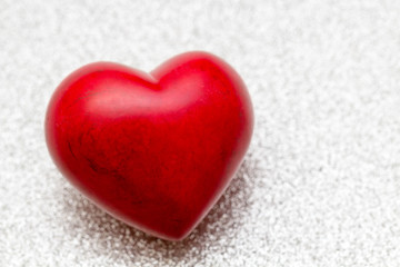 big red colored heart on silver background