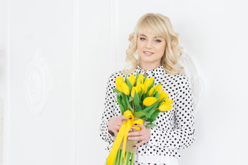 Happy woman with yellow tulips