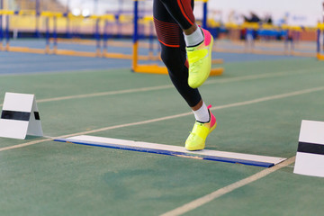 Sportsman landing his leg on board before taking off in long jump or tripple jump competition