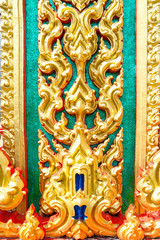 Gold Thai art of Sculpture on the wall of temple in Thailand.