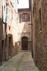 Fototapeta na wymiar Small road in Urbino old downtown, central Italy