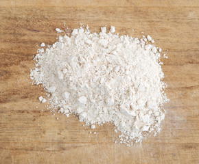 Fototapeta na wymiar Quinoa flour on a wood cutting board.