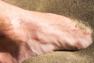 Fototapeta premium Foot in the Sand