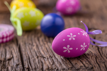 Easter. Multicolored easter eggs in a basket on a wooden table.