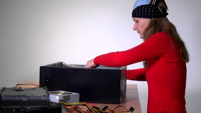 Female engineer remove computer motherboard