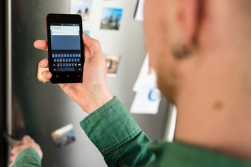 Person hands holding smartphone and searching for places to eat in browser