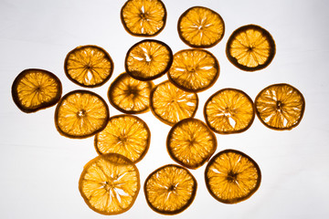 dry orange slices on a luminous white background