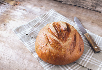 Fresh crispy bread kitchen towel, kitchen wooden background