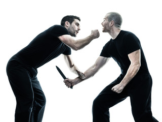 two caucasian men krav maga fighters fighting isolated silhouette on white background