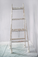 Renovation of a wall in empty room with ladder