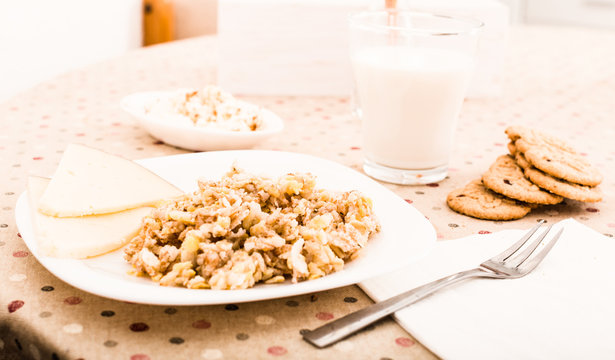 porridge from flakes of different varieties of grain, cheese and milk for breakfast