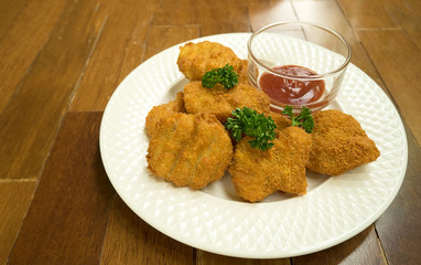 Fried chicken nuggets on wood table