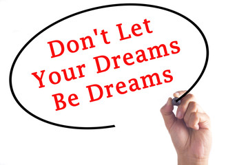 Hand writing Don't Let Your Dreams Be Dreams on transparent board