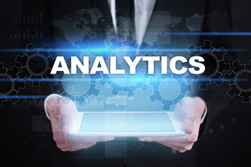 Businessman holding tablet PC with analytics concept.