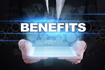 Businessman holding tablet PC with benefits concept.