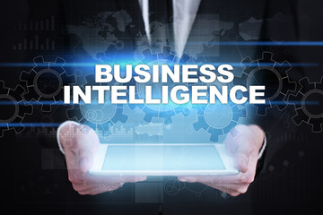 Businessman holding tablet PC with business intelligence concept.