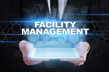 Businessman holding tablet PC with facility management concept.