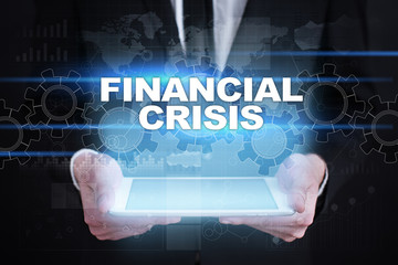 Businessman holding tablet PC with financial crisis concept.