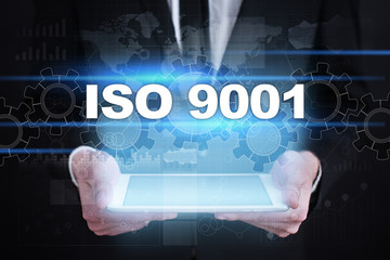 Fototapeta na wymiar Businessman holding tablet PC with iso 9001 concept.