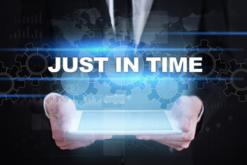 Businessman holding tablet PC with just in time concept.