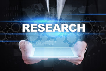 Businessman holding tablet PC with research concept.