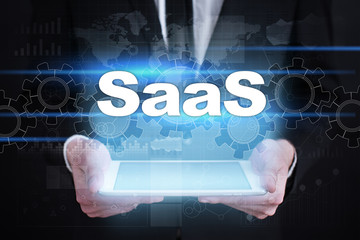 Businessman holding tablet PC with saas concept.