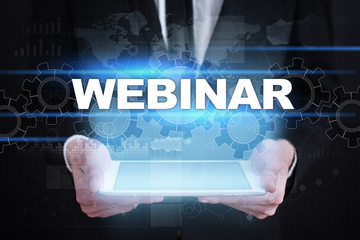 Businessman holding tablet PC with webinar concept.