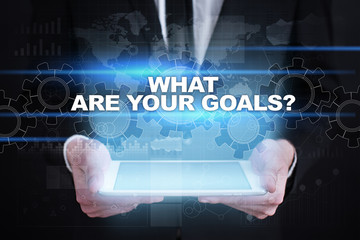 Fototapeta na wymiar Businessman holding tablet PC with what are your goals concept.