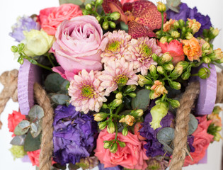 Bouquet of flowers in wooden box 