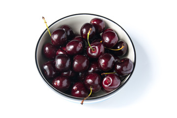 Close up fresh cherries in bowl on table
