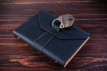 leather organizer with old padlock - 138709897