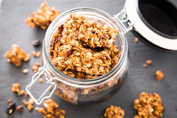 Healthy breakfast. Fresh granola, muesli in a glass jar. copy space.Organic oat,almond and cherry