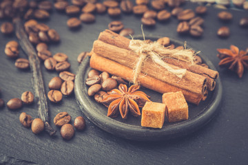 Roasted coffee beans background. Coffee beans with copy space for text. Seasoning. Spice. Cinnamon. Badian. Vanilla