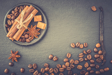 Roasted coffee beans background. Coffee beans with copy space for text. Seasoning. Spice. Cinnamon. Badian. Vanilla