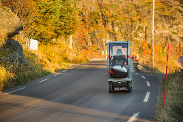 A compact electric vehicle specially  for people with disabilities on the road.