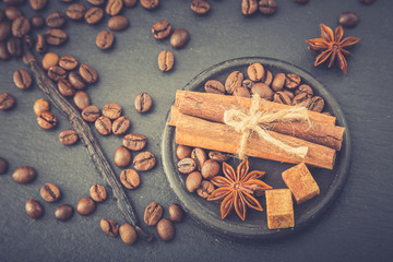 Roasted coffee beans background. Coffee beans with copy space for text. Seasoning. Spice. Cinnamon. Badian. Vanilla