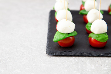 Caprese salad. Skewers with tomato and mozzarella with basil.