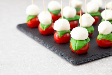 Caprese salad. Skewers with tomato and mozzarella with basil.