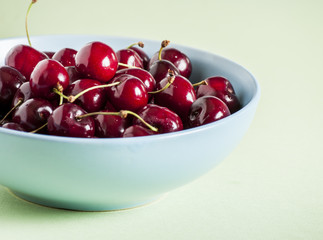 Red cherries in antique bowl